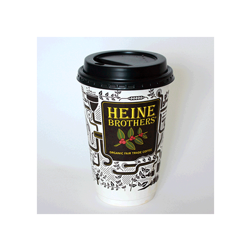 A Heine Brothers coffee cup with a black lid, decorated with black and white illustrations and the Heine Brothers logo, which reads Organic Fair Trade Coffee.