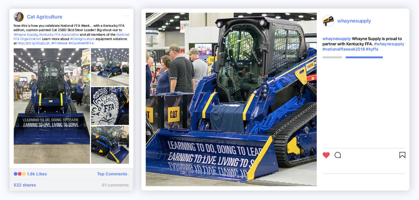 A blue skid steer loader with yellow accents is displayed at an indoor event, featuring the text “Learning to Do, Doing to Learn, Earning to Live, Living to Serve” on its blade. People are observing the equipment in the background.