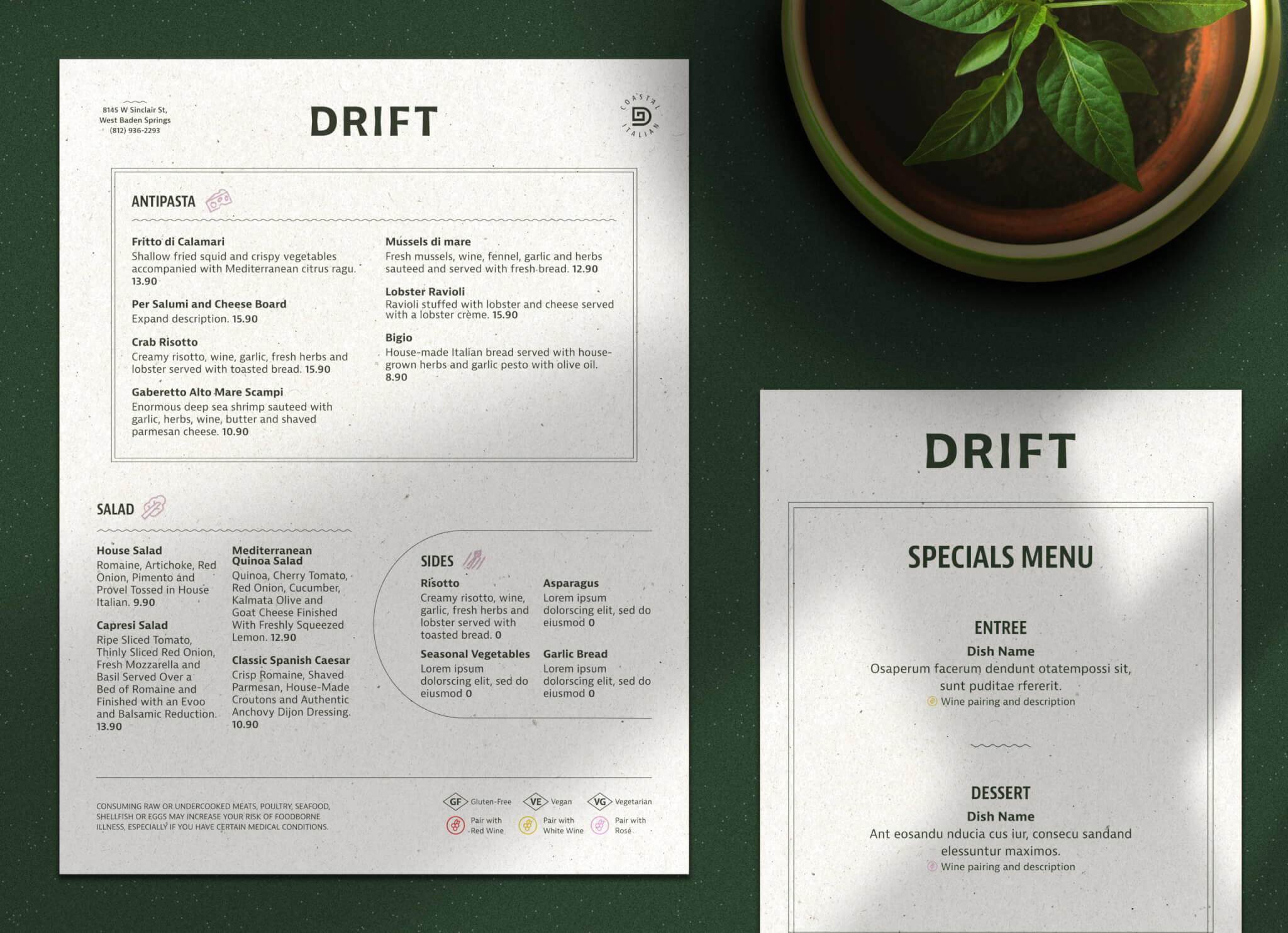 Two Drift restaurant menus are on a dark green surface next to a potted plant. The larger menu lists antipasti, salads, and sides, while the smaller menu is titled Specials Menu with sections for entree and dessert.