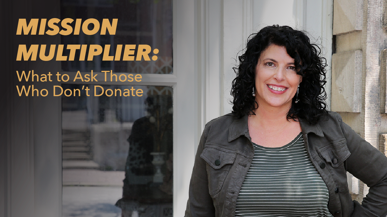A woman with curly dark hair smiles while standing outside against a stone wall. Text beside her reads, “MISSION MULTIPLIER: What to Ask Those Who Don’t Donate.”.