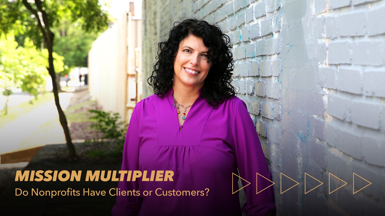 Smiling woman with curly dark hair and a purple blouse stands by a light-colored brick wall. Text reads, MISSION MULTIPLIER: Do Nonprofits Have Clients or Customers? Triangular arrow graphics line the bottom right.