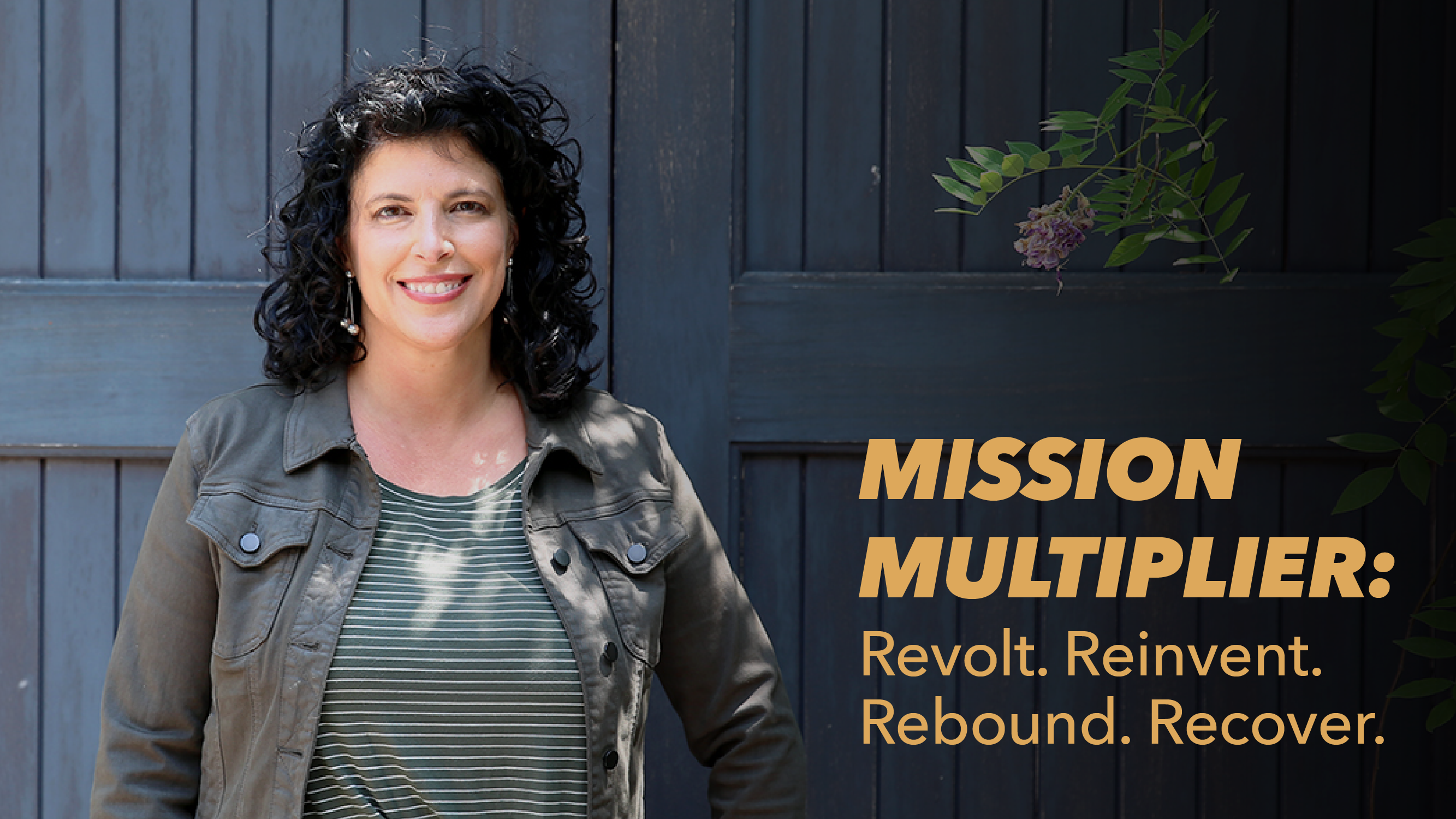A woman with curly dark hair stands smiling in front of a dark wooden wall. Text beside her reads: MISSION MULTIPLIER: Revolt. Reinvent. Rebound. Recover. Green foliage is partially visible on the right.