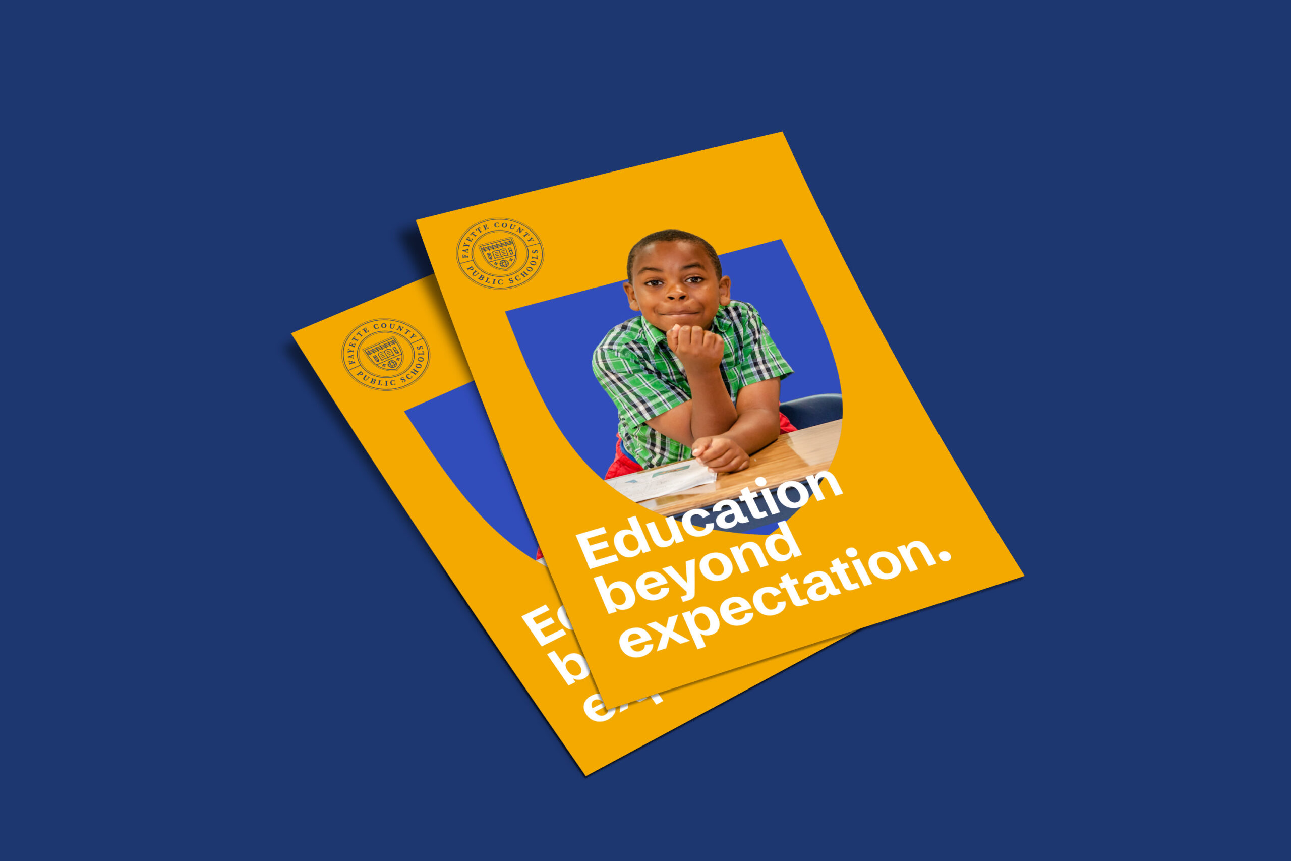 Two yellow flyers with a photo of a boy in a green checkered shirt sitting at a desk, resting his chin on his hand. The text reads, Education beyond expectation. The flyers are on a blue background.