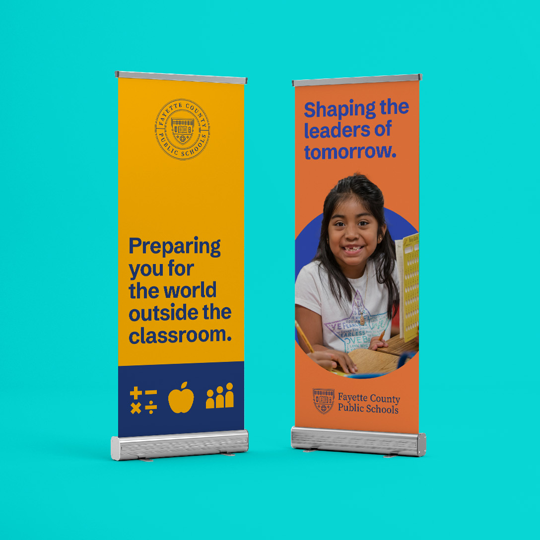 Two vertical banners for Fayette County Public Schools on a turquoise background. One features text and icons, the other shows a smiling girl with a laptop and the text “Shaping the leaders of tomorrow.”.