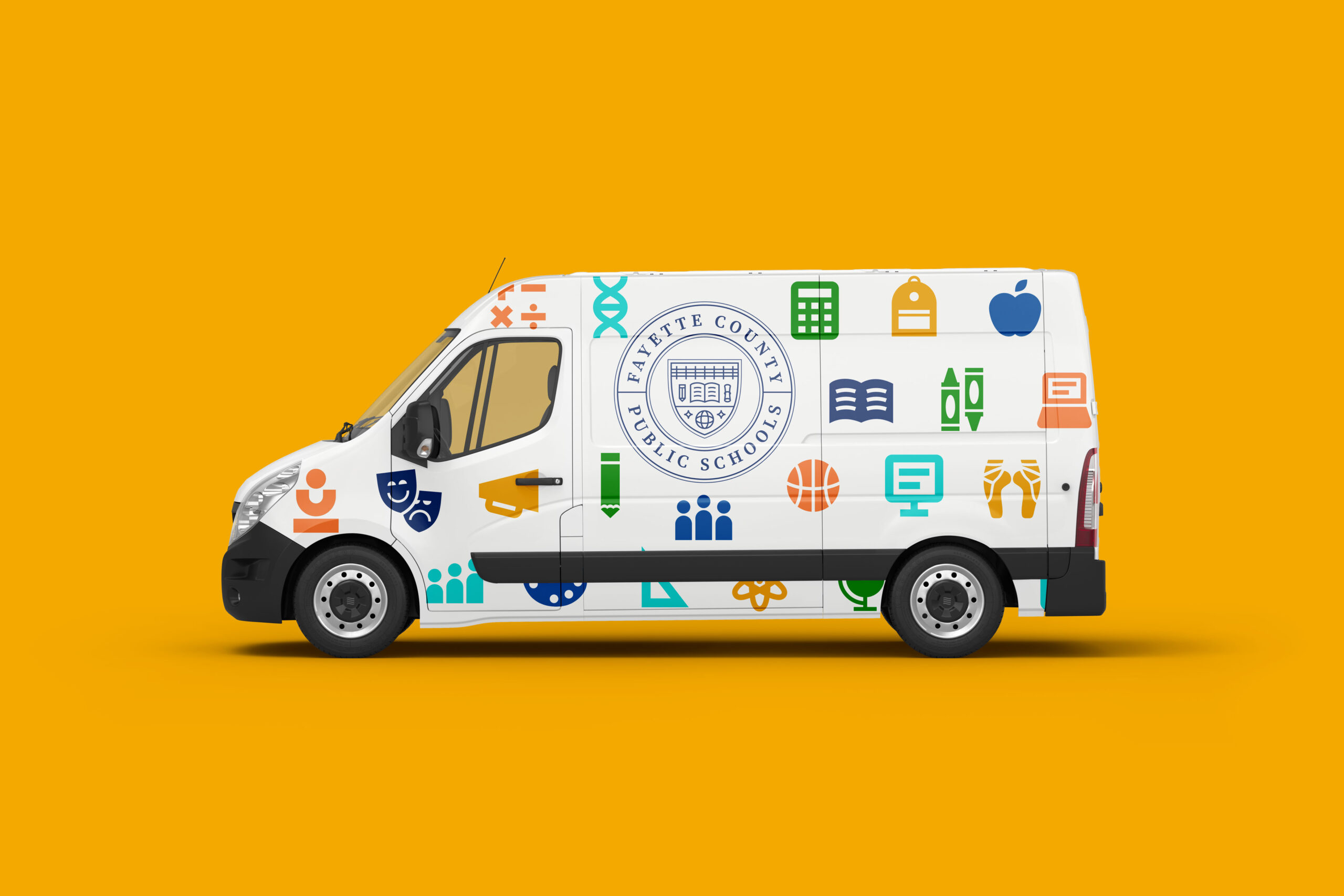 A white van with colorful school-related icons and the Wayne County Public Schools logo is shown on a solid yellow background. The icons include books, a globe, a microscope, a computer, and more.