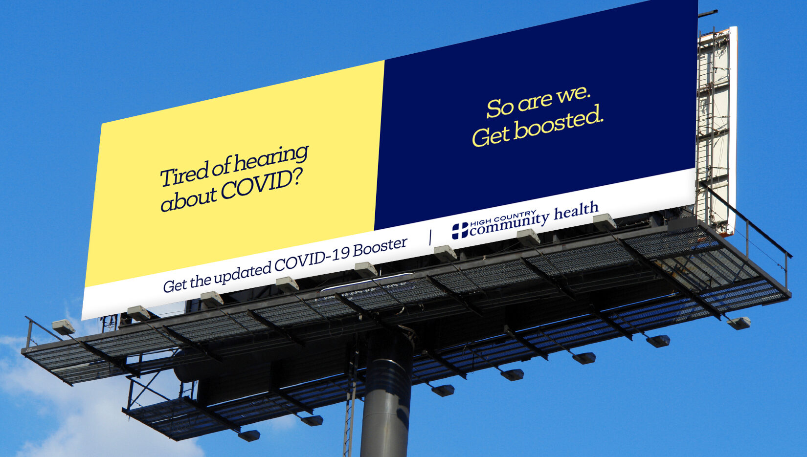 A billboard with the text Tired of hearing about COVID? So are we. Get boosted. and Get the updated COVID-19 Booster above a logo for High Country Community Health, against a blue sky.
