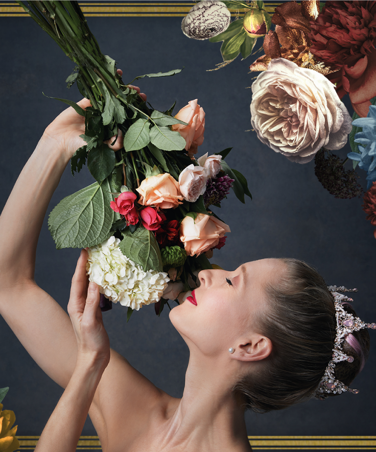 A woman with a jeweled headpiece and red lipstick holds a bouquet of colorful flowers above her face, eyes closed, as if inhaling their scent. Ornate floral arrangements frame the dark background.