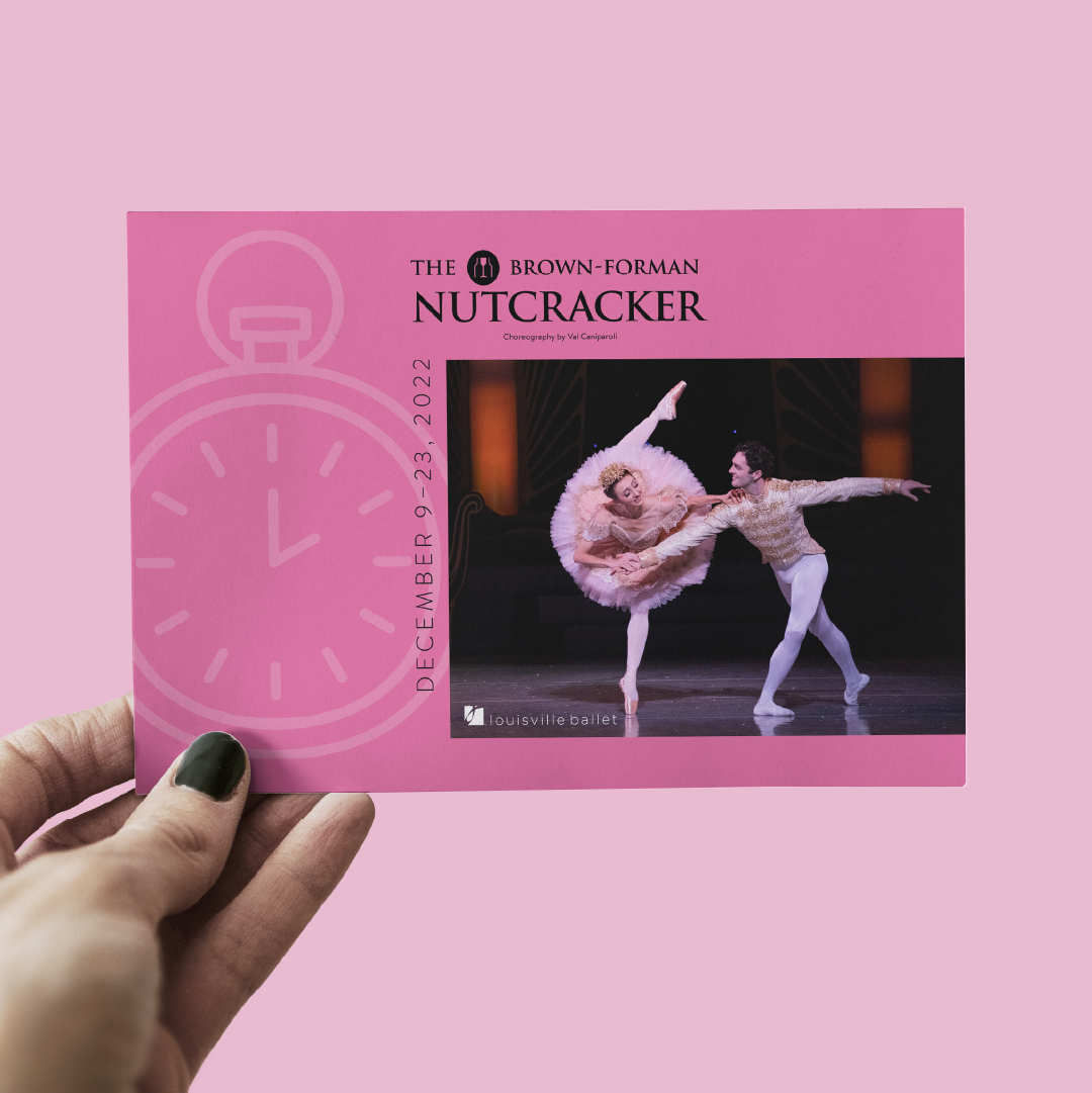 A hand holds a pink postcard for the Brown-Forman Nutcracker, showing two ballet dancers performing on stage. The card has a clock graphic and event dates: December 9–23, 2022. Louisville Ballet is mentioned at the bottom.
